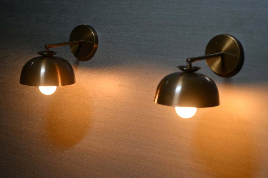 Handmade brass dome shade wall sconce mounted on wall – side angle view