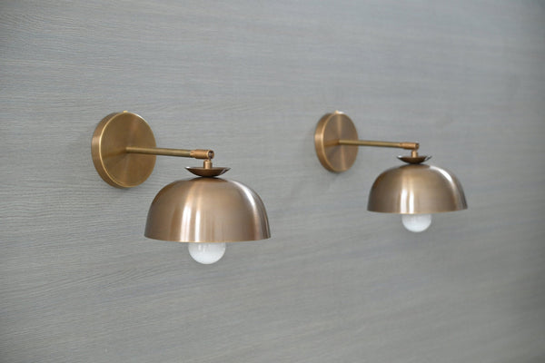 Handmade brass dome shade wall sconce mounted on wall – side angle view