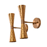 Angled view of brass double cone wall sconces showing perforated detailing and brushed brass finish