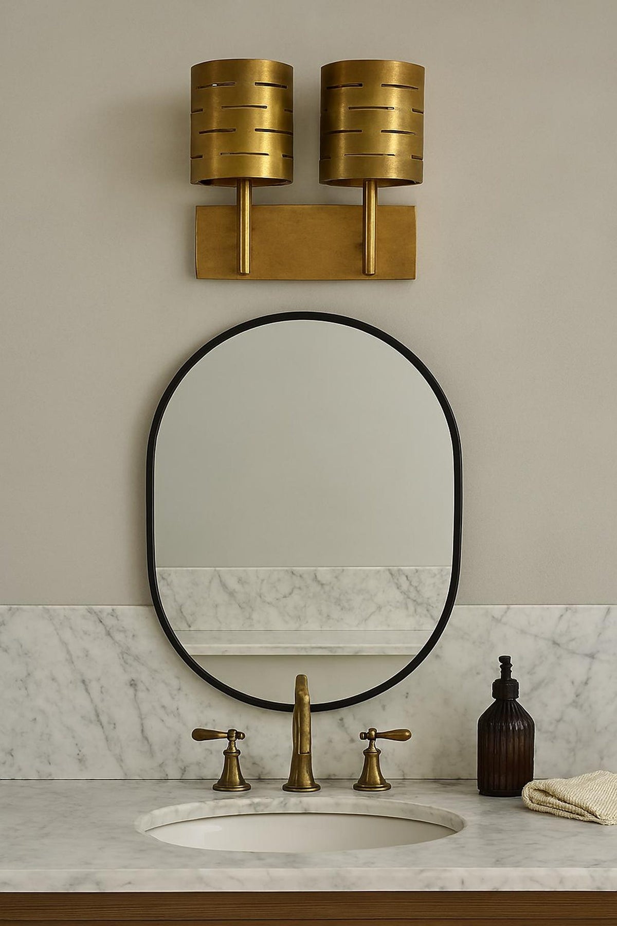 Brushed brass dual wall sconce installed above bathroom vanity mirror, mid-century modern industrial bathroom lighting