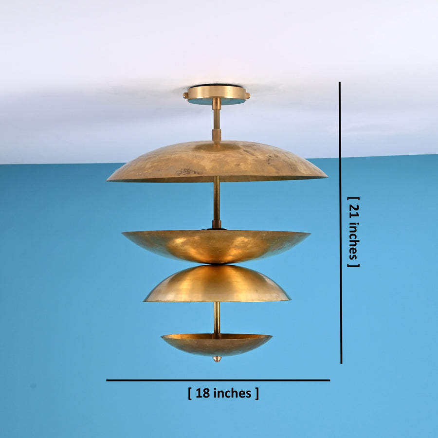 Layered brass disc flush mount ceiling light with sculpted bowl shades, handcrafted in solid brass with warm indirect ambient lighting.
