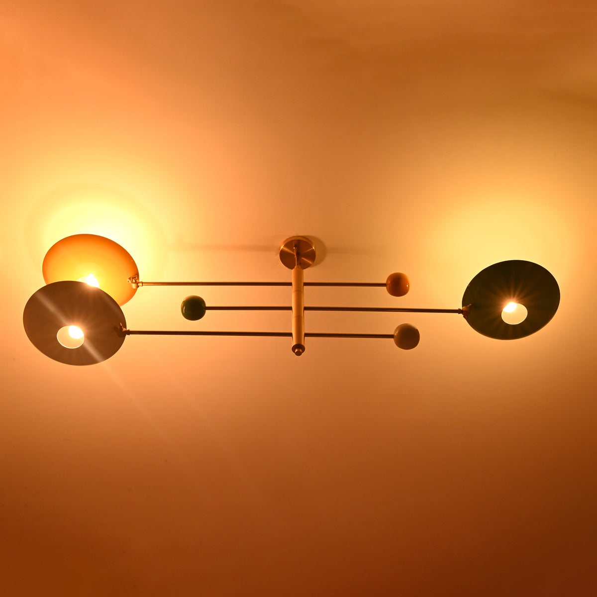 Three light brass flush mount ceiling light casting warm indirect ambient lighting across the ceiling