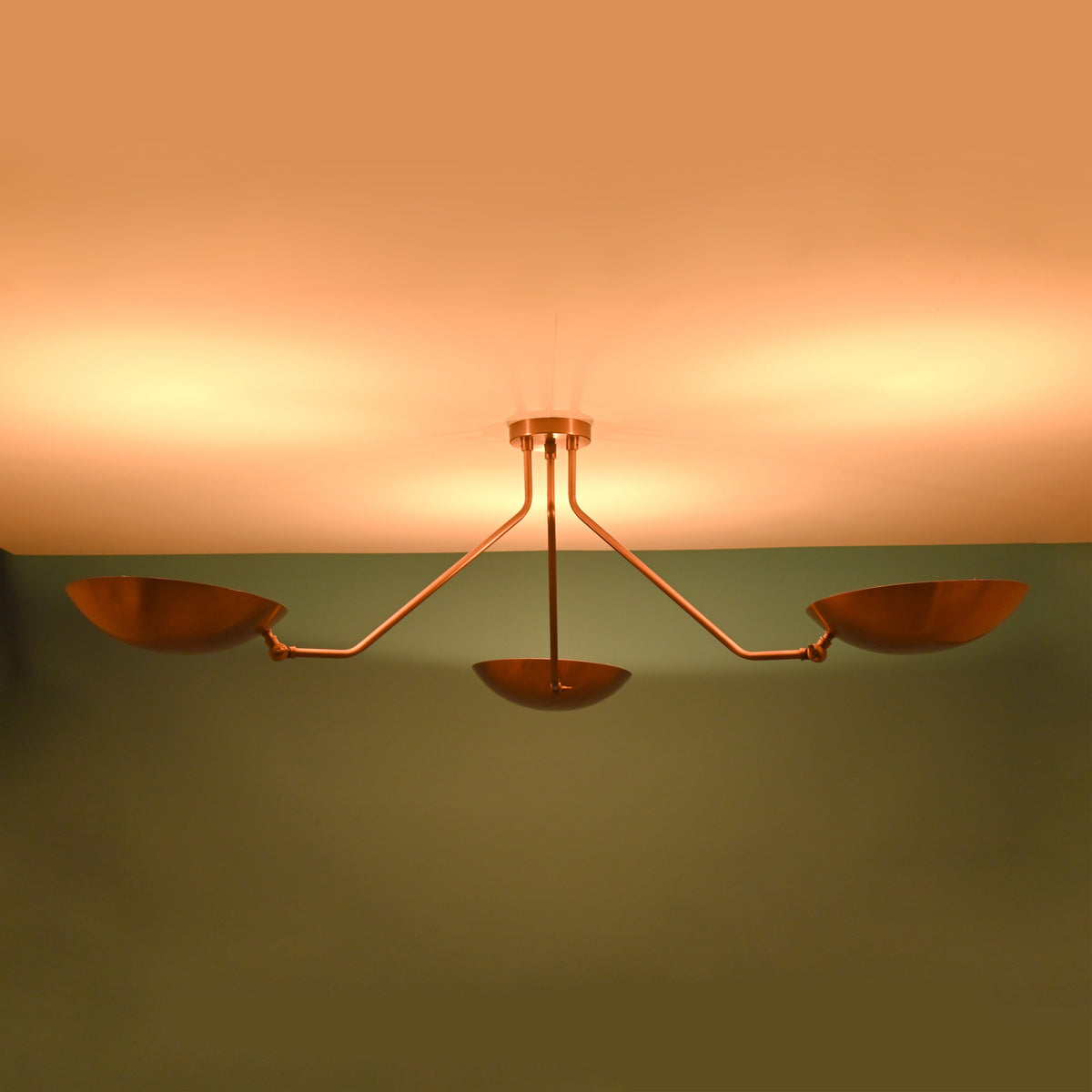 Brass flush mount ceiling light emitting warm ambient indirect uplighting ideal for modern living and dining spaces