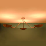 Brass flush mount ceiling light emitting warm ambient indirect uplighting ideal for modern living and dining spaces
