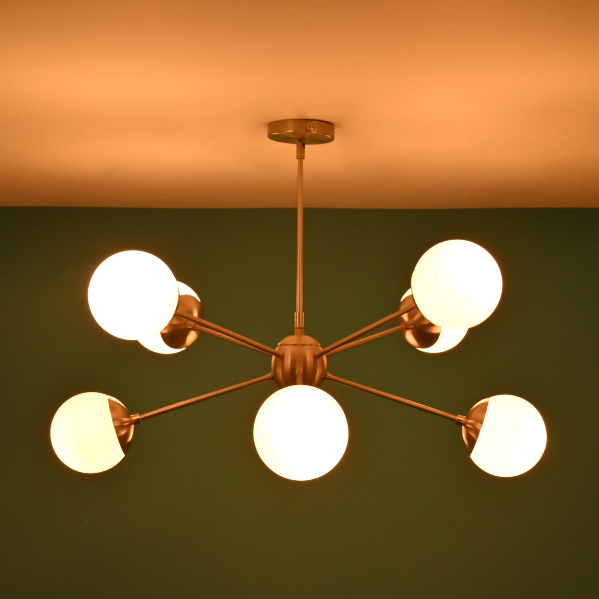 Brass globe chandelier emitting warm ambient lighting ideal for dining rooms and living spaces