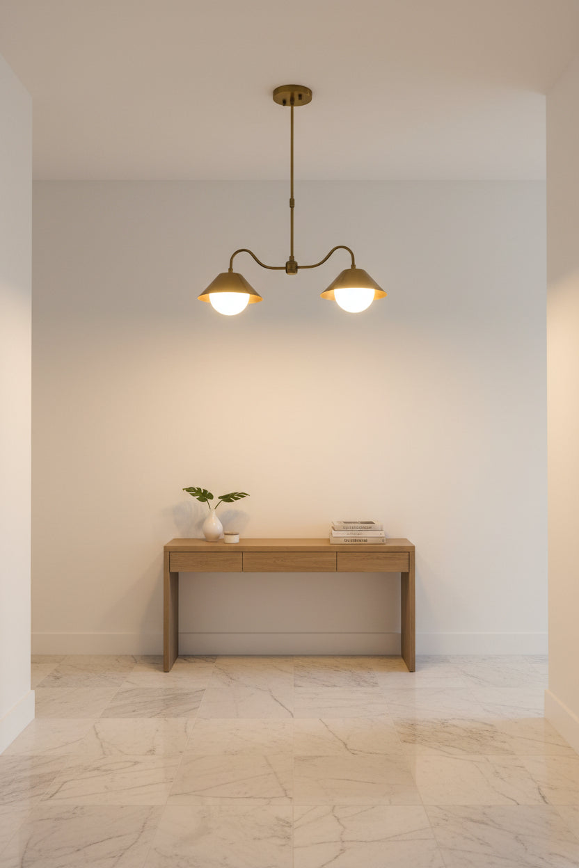 Modern brass globe pendant lamp with two G9 lights and sculptural curved frame for warm ceiling illumination