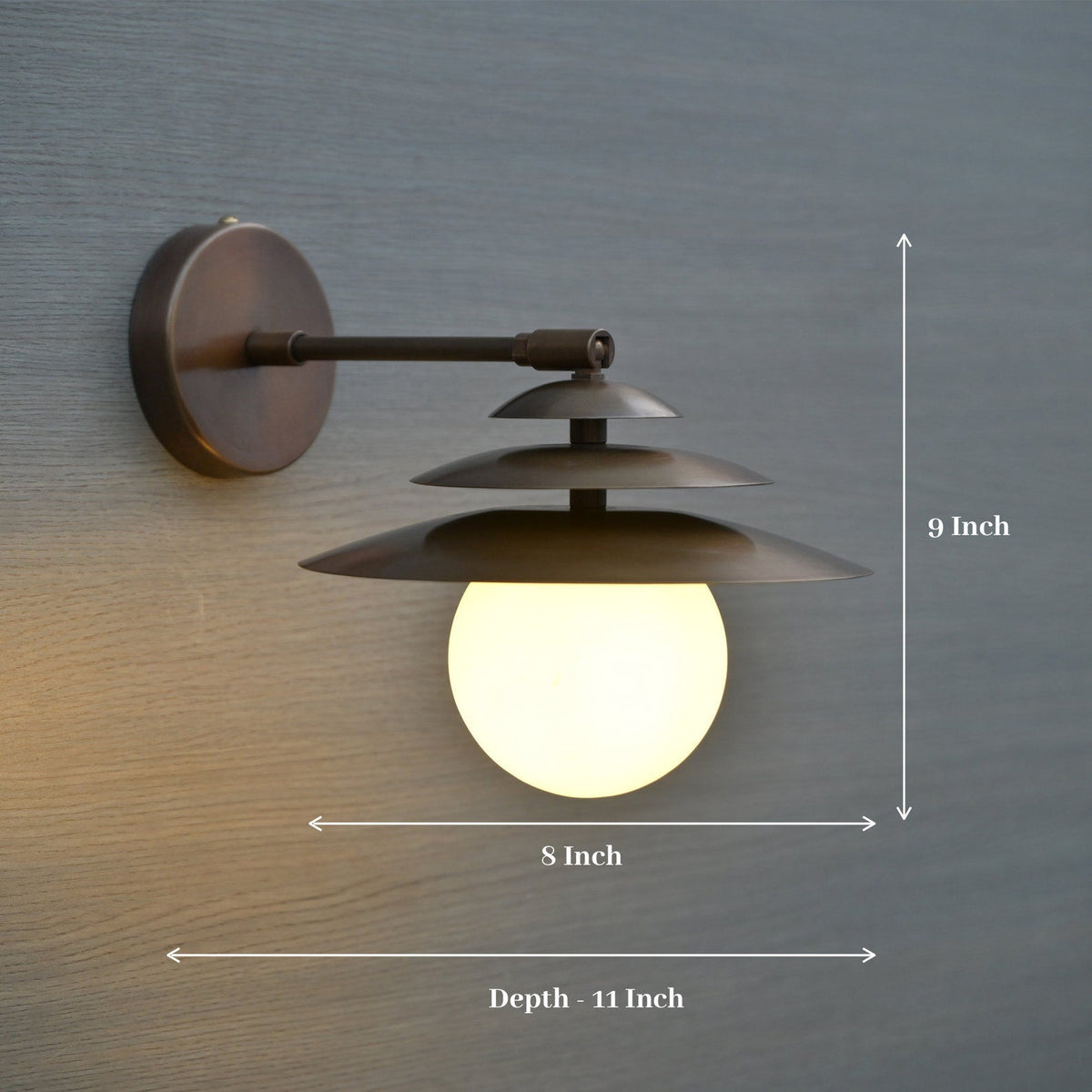 Dimensioned image of brass globe wall sconce with layered shades, measuring 8 inch width, 9 inch height, and 11 inch depth