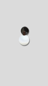 Top view of handcrafted brass wall light with frosted glass globe