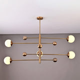 Brass Leaf Studio Aurelia globe chandelier featuring a 5 light linear design with solid brass construction and opal glass shades