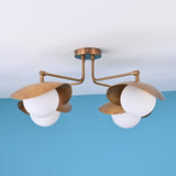 Angled perspective of handcrafted brass flush mount ceiling light with opal globes and minimalist styling