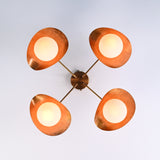 Bottom view of brass flush mount ceiling light showing four evenly spaced opal globe diffusers