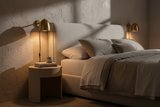 A dome-shaped wall sconce with a brushed brass finish, shown against a plain white background.