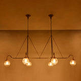 Brass Leaf Studio ribbed glass globe chandelier with six lights, brass frame, and luxury statement ceiling design