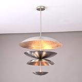 Silver-finish tiered metal disc pendant light featuring layered reflective bowls and warm interior glow.