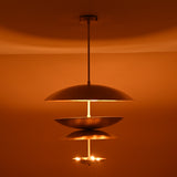 Warm ambient glow from triple bowl brass chandelier with brushed finish, handcrafted by Brass Leaf Studio