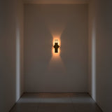 Brass patina rectangular wall light with slim vertical tube design and warm ambient illumination for hallway or bedroom walls