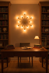 Closeup of brass patina wall sconce showing cylindrical bulb holders, slim arms, and rounded center canopy details