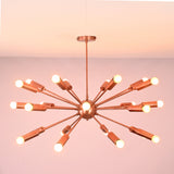 Angled view of brass sputnik chandelier highlighting sculptural arms and glowing exposed bulbs.