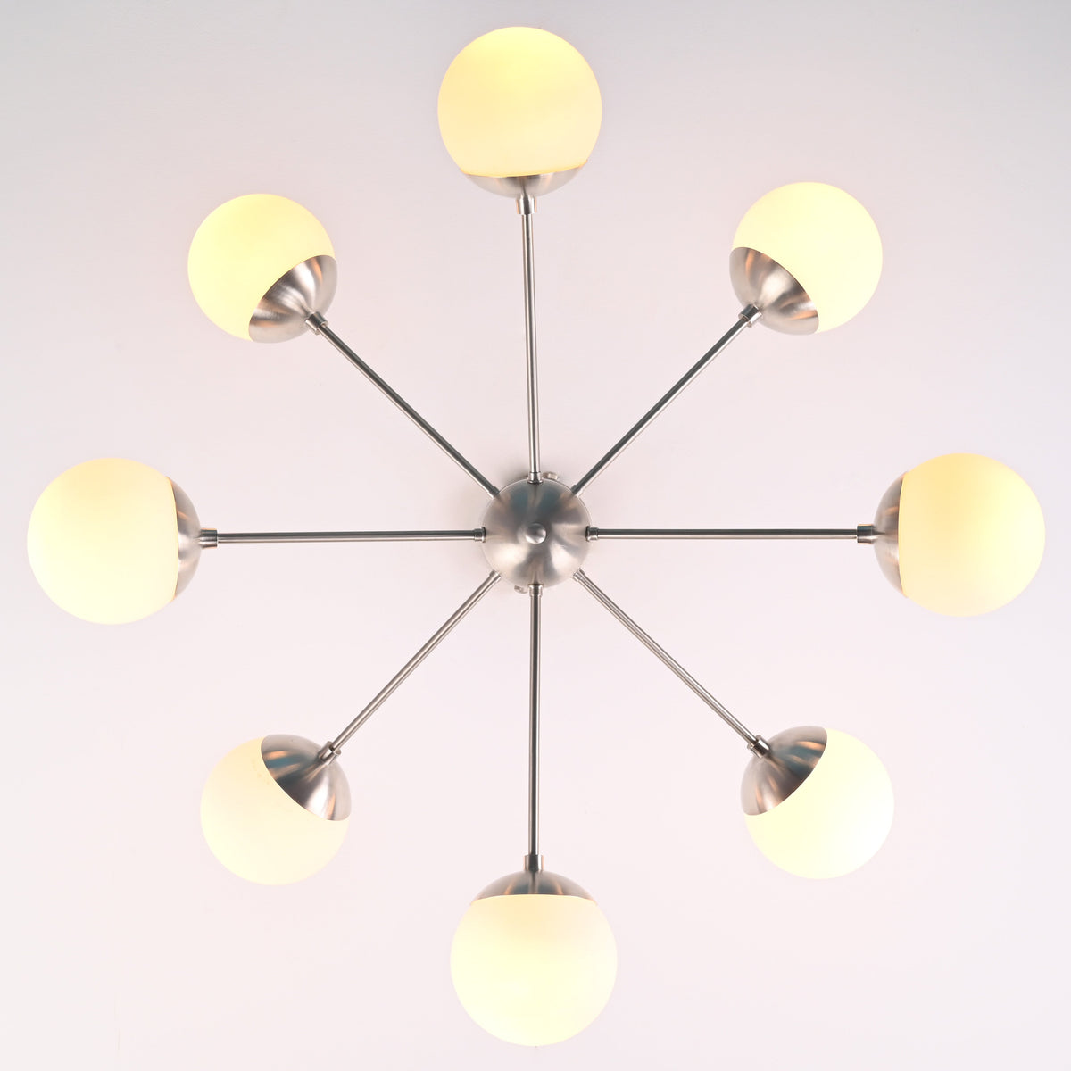 Bottom view of 8 light brass sputnik chandelier showing radial arms and evenly spaced globe shades