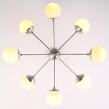 Bottom view of 8 light brass sputnik chandelier showing radial arms and evenly spaced globe shades