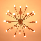 Bottom view of brass sputnik chandelier illuminated in dark setting with soft warm light.