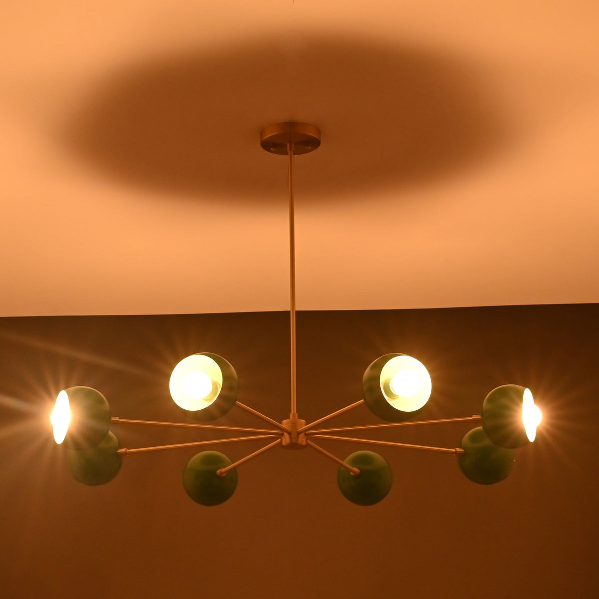 Central hub detail of handcrafted brass sputnik chandelier with radial arms and premium brushed finish