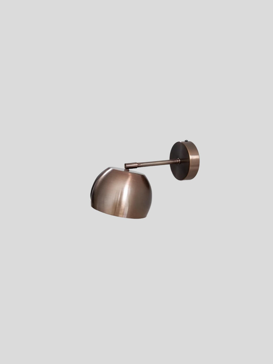 Side view of antique patina brass wall light with adjustable arm and brushed finish by Brass Leaf Studio