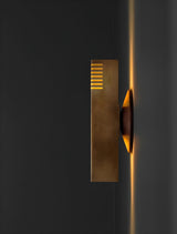 Side view of brass wall sconce showing slim profile and upward and downward indirect light beam