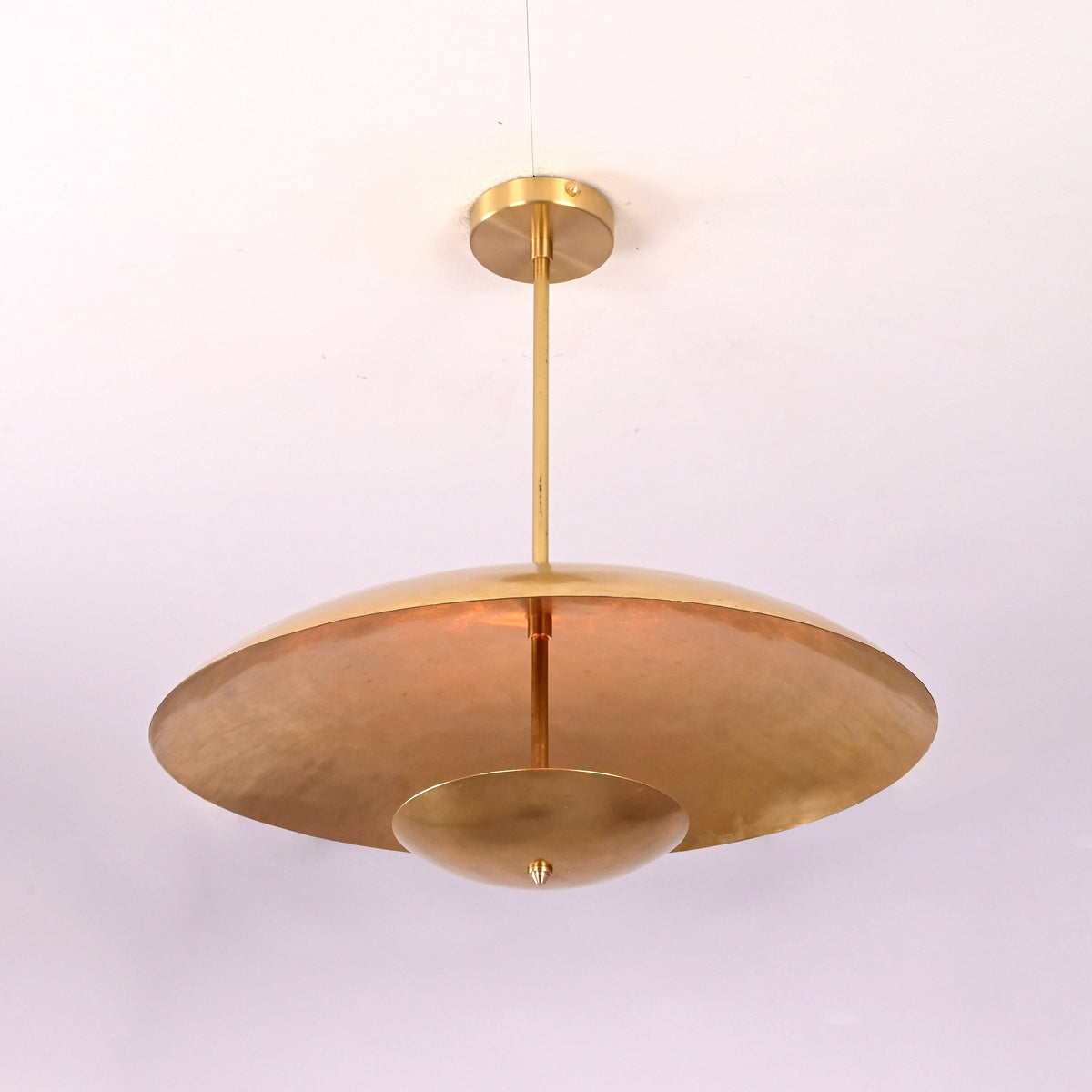 Angled view of brushed brass 3 light pendant chandelier showcasing layered disc structure.