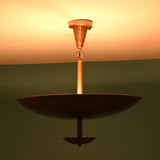 Brushed brass bowl disc chandelier illuminated with warm indirect lighting creating a soft ambient glow across the ceiling