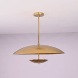 Front view of brushed brass disc pendant light with layered bowl shades and minimalist profile.