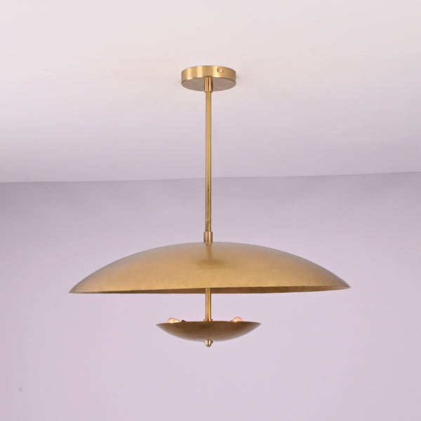Front view of brushed brass disc pendant light with layered bowl shades and minimalist profile.