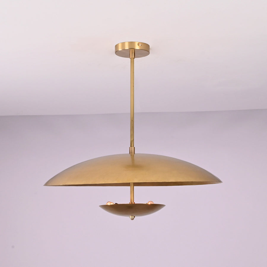 Front view of brushed brass disc pendant light with layered bowl shades and minimalist profile.