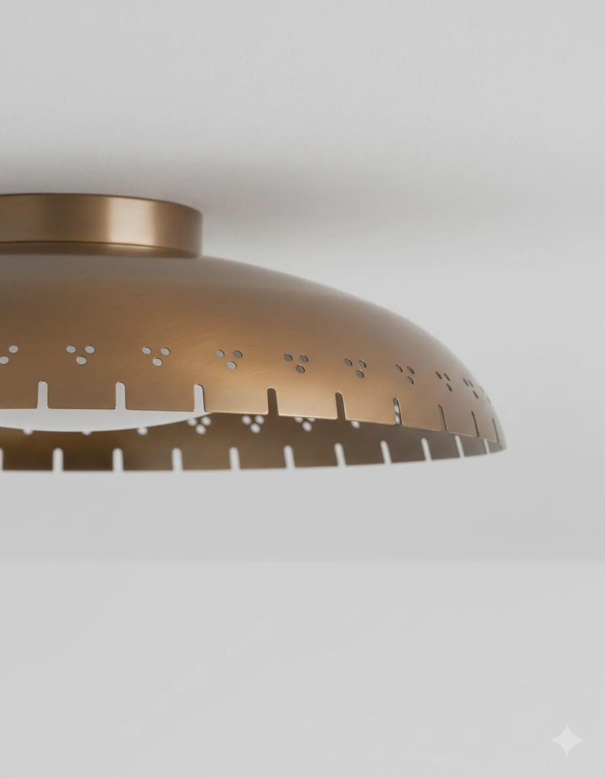 Close-up of brushed brass flush mount ceiling light showing perforated detailing and refined handcrafted finish