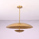 Side profile of modern brushed brass pendant light with wide bowl shade and clean silhouette.