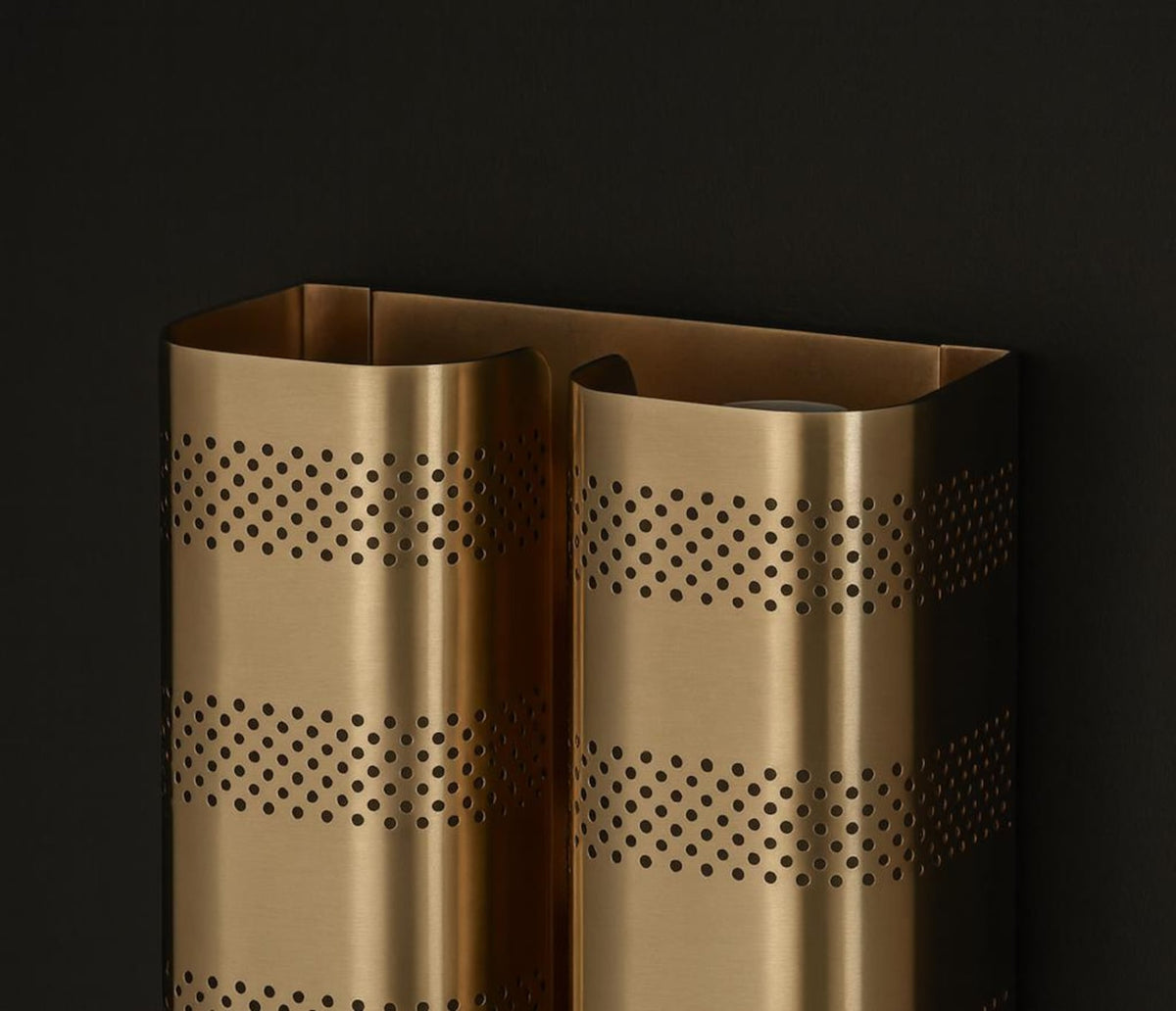 Close-up detail of brushed brass perforated metal shade showing craftsmanship and premium finish