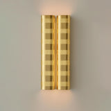 Brushed brass perforated wall sconce with warm ambient glow, modern industrial brass wall light by Brass Leaf Studio