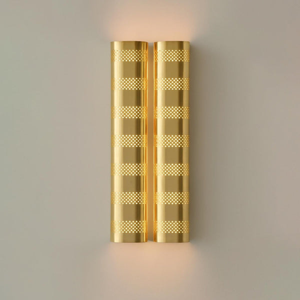 Brushed brass perforated wall sconce with warm ambient glow, modern industrial brass wall light by Brass Leaf Studio