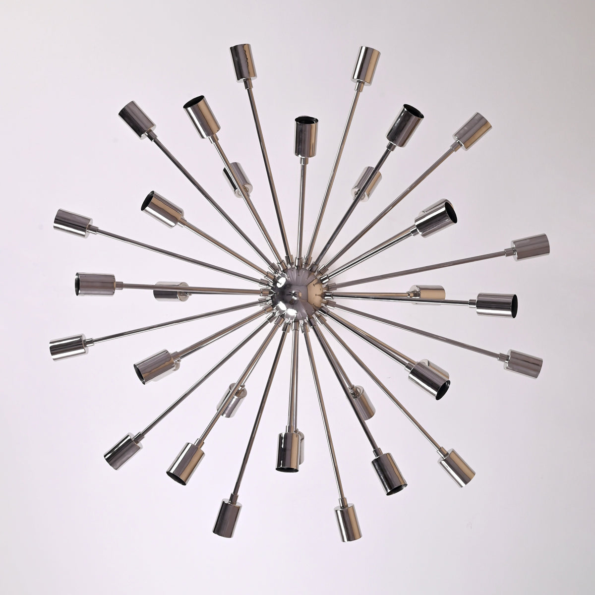 Top view of chrome Sputnik chandelier displaying 36 radiating brass arms in a modern geometric arrangement