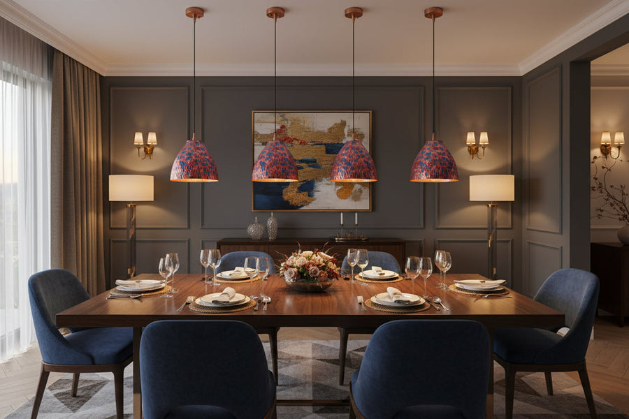 Set of four colorful copper pendant lights with black hanging cords and matching copper ceiling canopies