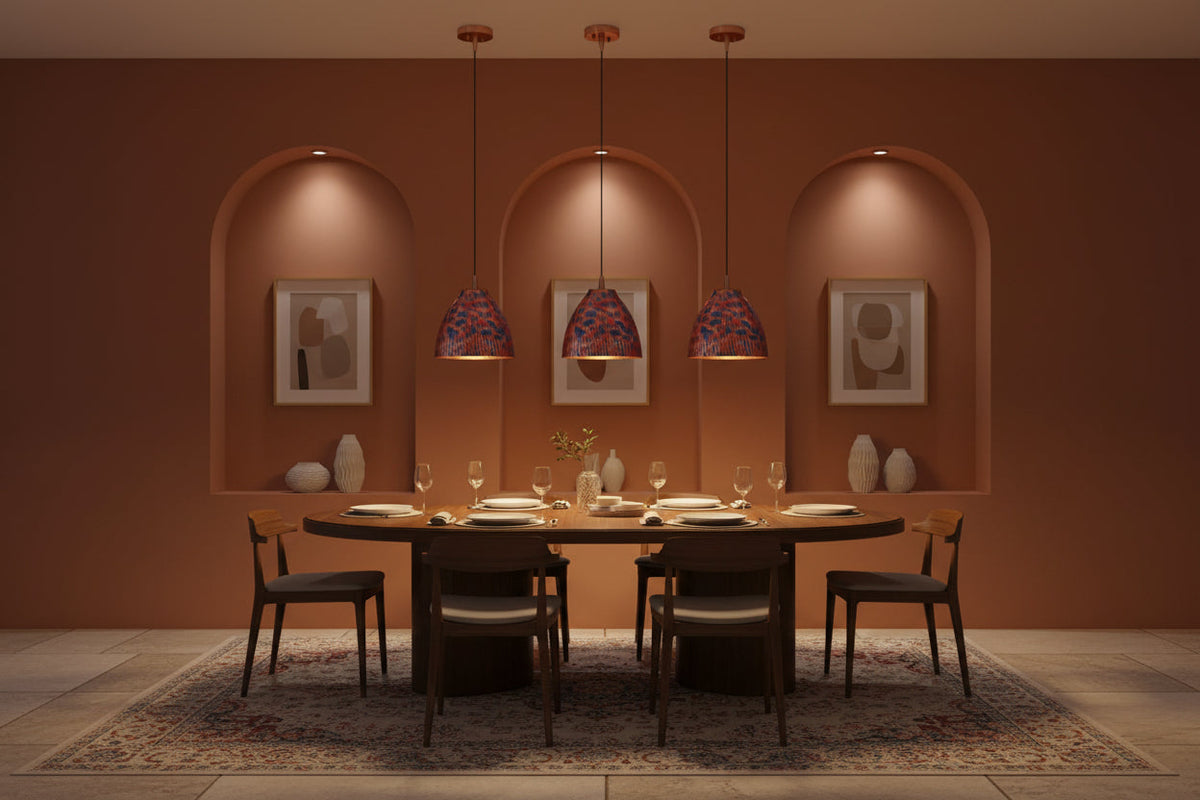 Colorful copper dome pendant lamp installed in a warm restaurant interior with red and blue patterned shade