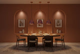 Colorful copper dome pendant lamp installed in a warm restaurant interior with red and blue patterned shade