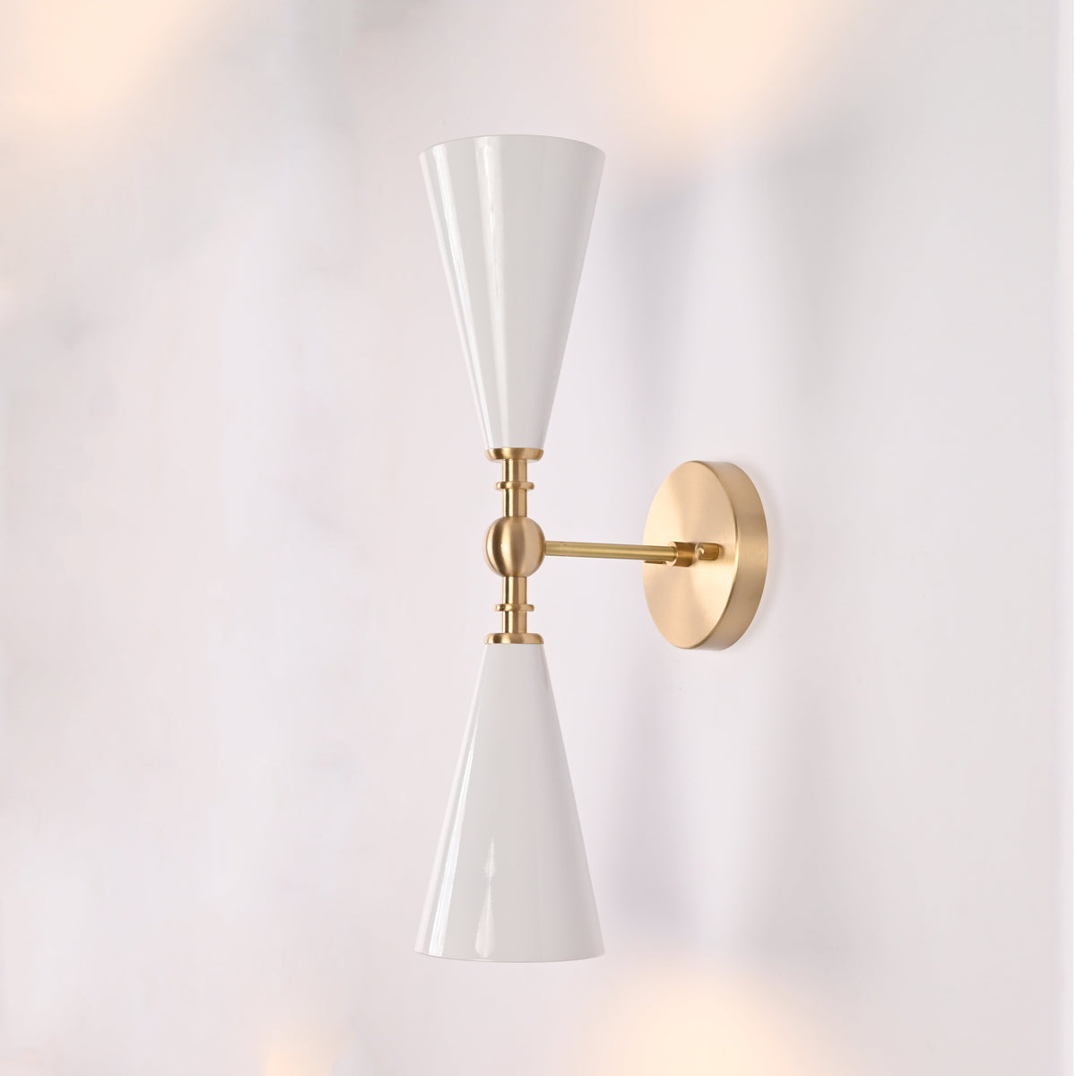Copenhagen double cone wall sconce shown in restaurant interior with warm up and down lighting effect