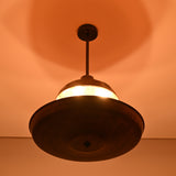 Moody lighting view of copper disc chandelier with warm glow, ideal for modern and industrial interiors