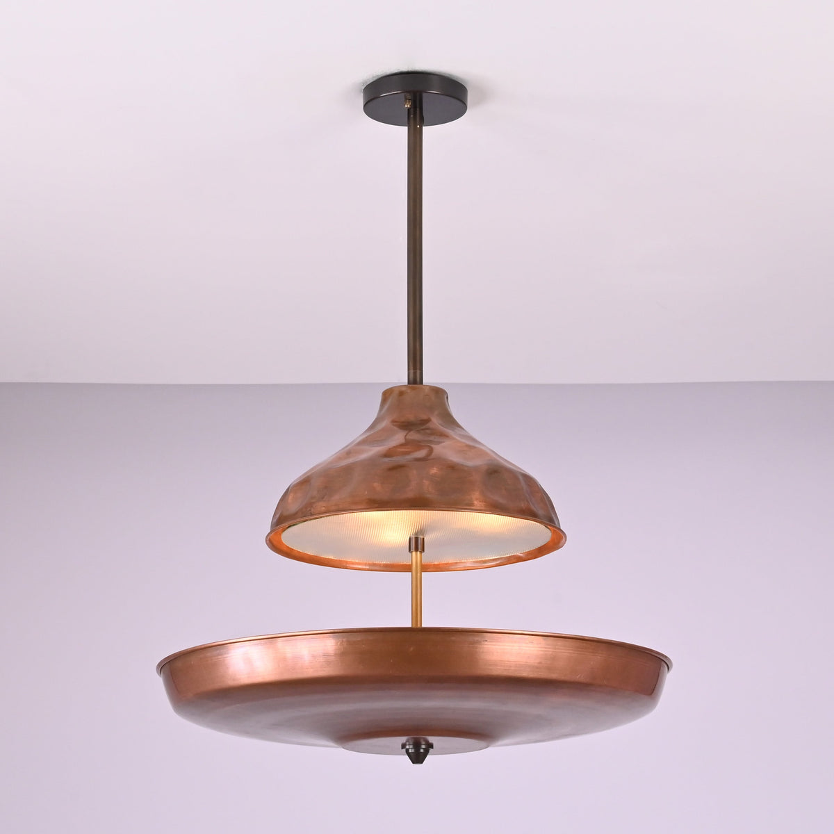 Underside view of handcrafted copper disc chandelier highlighting solid brass construction and smooth bowl form