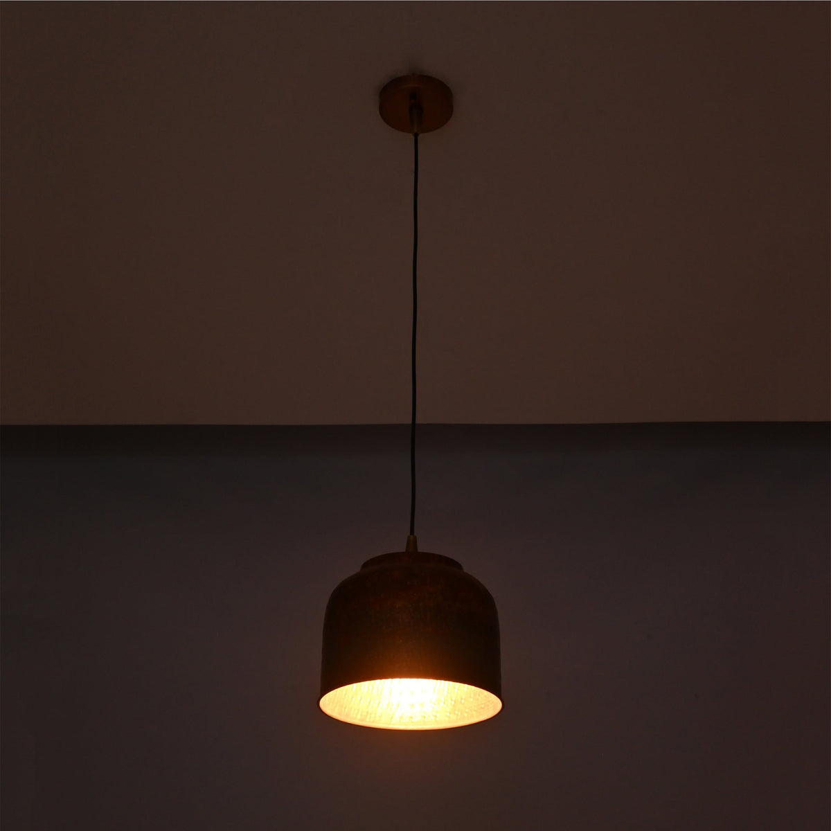 Copper drum pendant light front view showing rounded shade, black hanging cord, and matching ceiling canopy