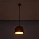 Copper drum pendant light front view showing rounded shade, black hanging cord, and matching ceiling canopy