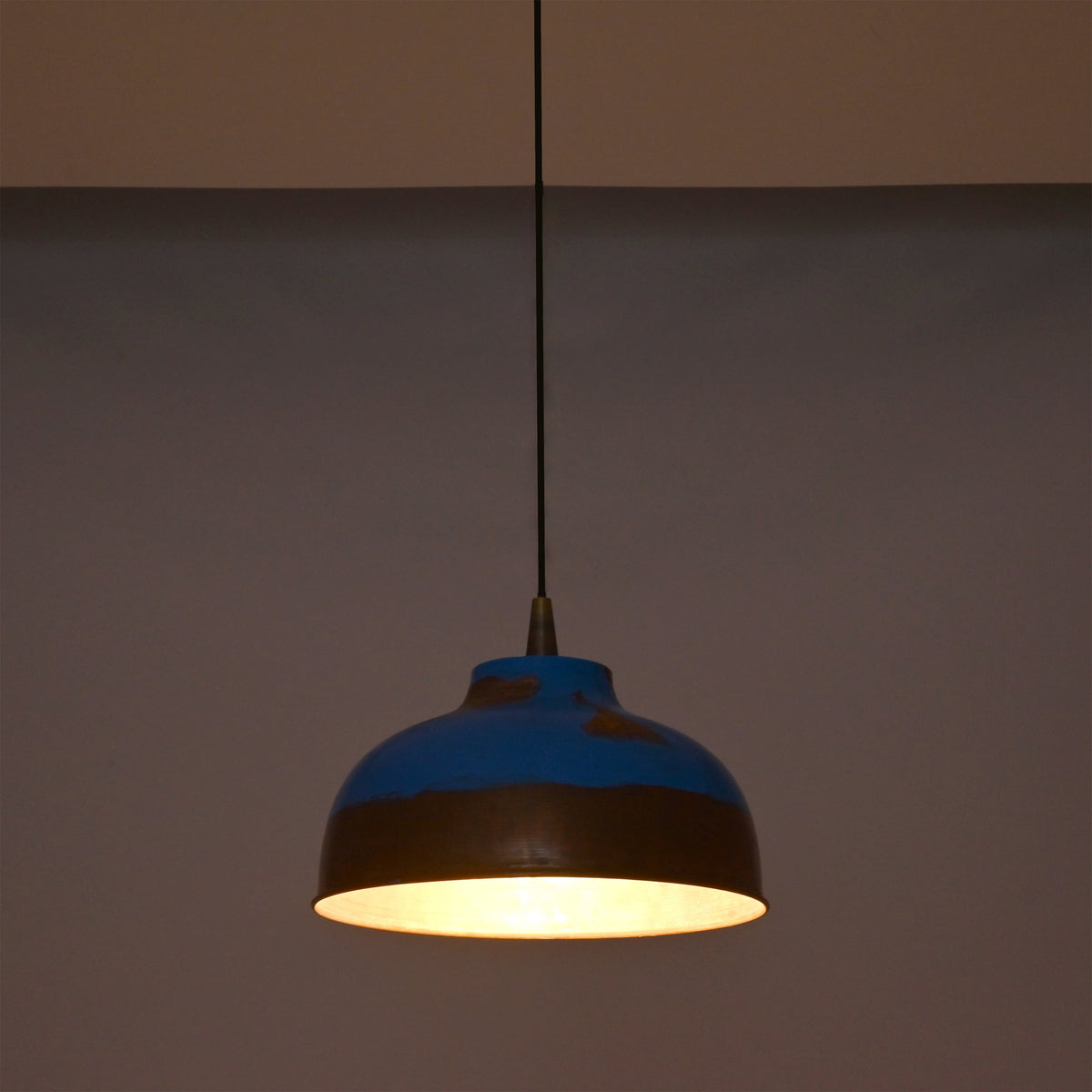 Multiple blue copper pendant lights arranged above a kitchen island for stylish task lighting