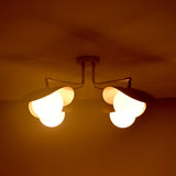 Curva brass flush mount illuminated in warm ambient light, creating a cozy and inviting ceiling glow for modern interiors.