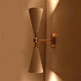 Customizable double cone wall sconce with enamel painted shades and brushed brass finish details